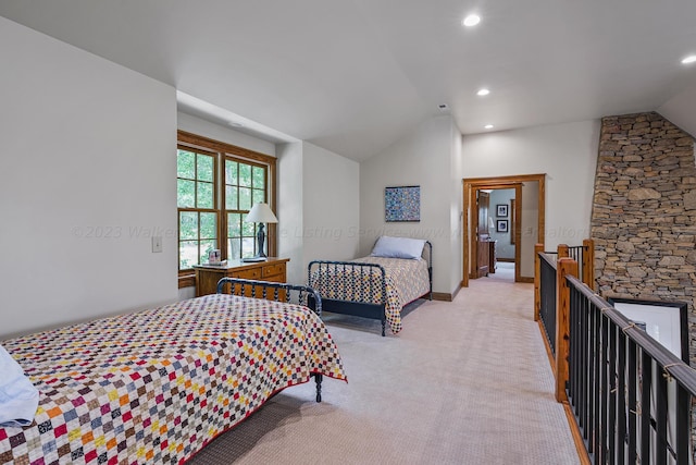 carpeted bedroom with lofted ceiling