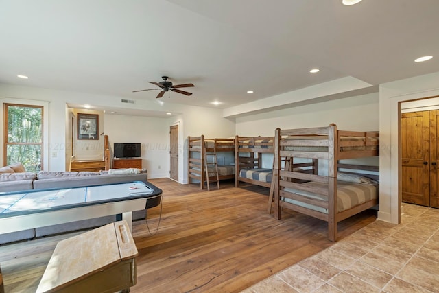 bedroom with ceiling fan and light hardwood / wood-style flooring