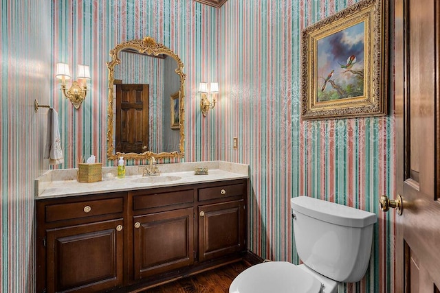 601 Glen Oaks Cir, Jasper, AL 35504 - half bathroom featuring vanity, wallpapered walls, and wood finished floors