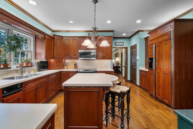601 Glen Oaks Cir, Jasper, AL 35504 - kitchen featuring paneled appliances, light wood-type flooring, ornamental molding, light countertops, and a breakfast bar area