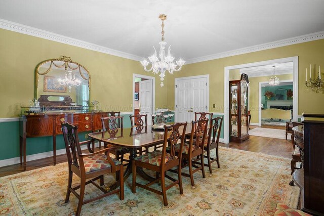 601 Glen Oaks Cir, Jasper, AL 35504 - dining space with a chandelier, wood finished floors, and ornamental molding