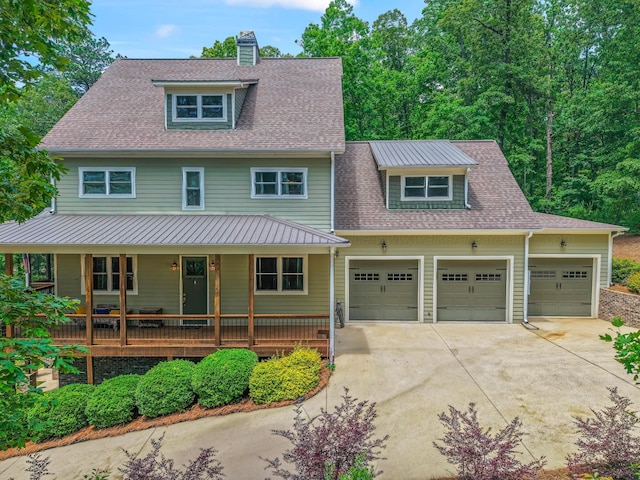 136 Grand Magnolia, Jasper, AL 35504 - view of front facade with driveway, covered porch, a garage, a chimney, and roof with shingles