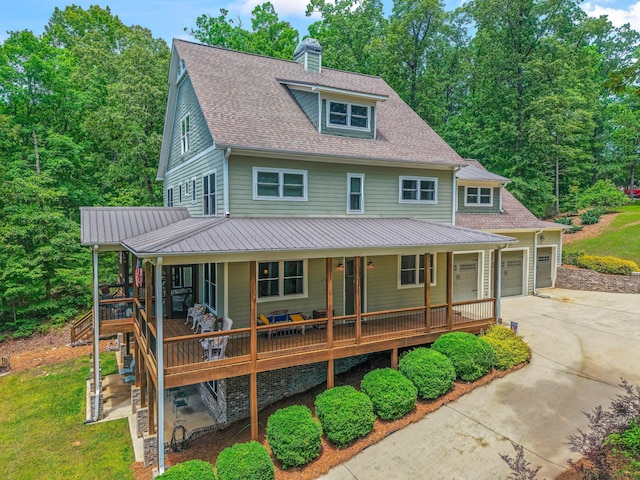 136 Grand Magnolia, Jasper, AL 35504 - view of front of home with concrete driveway, covered porch, a chimney, an attached garage, and a shingled roof