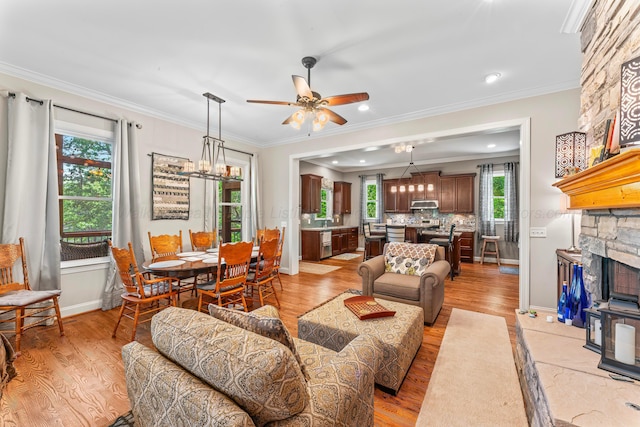 136 Grand Magnolia, Jasper, AL 35504 - living room with light wood finished floors, a ceiling fan, ornamental molding, baseboards, and a chandelier