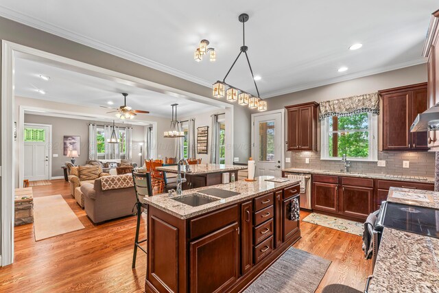 136 Grand Magnolia, Jasper, AL 35504 - kitchen with a sink, a center island with sink, a kitchen bar, light wood-type flooring, and plenty of natural light