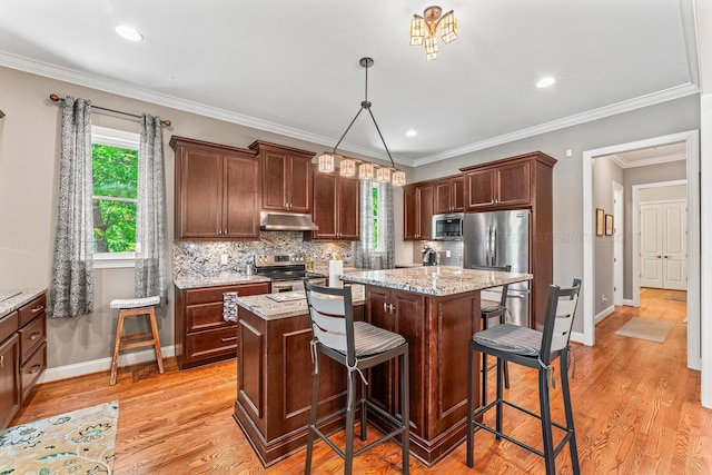 136 Grand Magnolia, Jasper, AL 35504 - kitchen with under cabinet range hood, stainless steel appliances, a kitchen island, baseboards, and recessed lighting