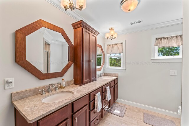 136 Grand Magnolia, Jasper, AL 35504 - bathroom with a chandelier, double vanity, baseboards, and ornamental molding