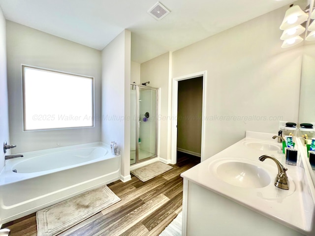 405 Meadow Way, Jasper, AL 35504 - full bath featuring a garden tub, a stall shower, wood finished floors, and double vanity