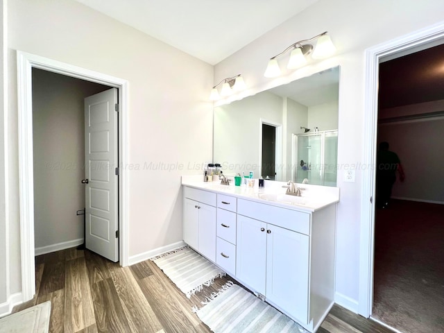 405 Meadow Way, Jasper, AL 35504 - full bathroom with double vanity, wood finished floors, and a stall shower