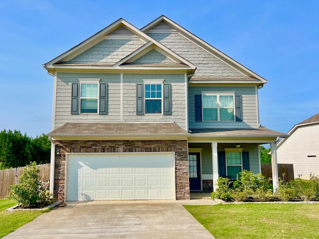 405 Meadow Way, Jasper, AL 35504 - craftsman-style house with a garage, concrete driveway, covered porch, and stone siding