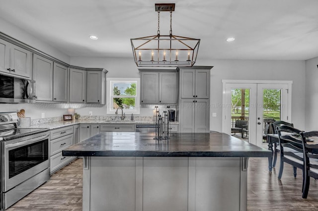 kitchen featuring gray cabinets, appliances with stainless steel finishes, french doors, and a sink