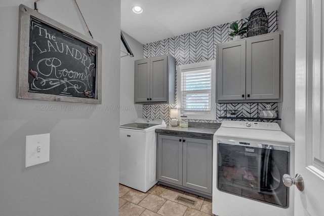washroom with recessed lighting, wallpapered walls, visible vents, washing machine and clothes dryer, and cabinet space