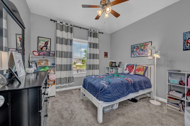 carpeted bedroom with ceiling fan and baseboards