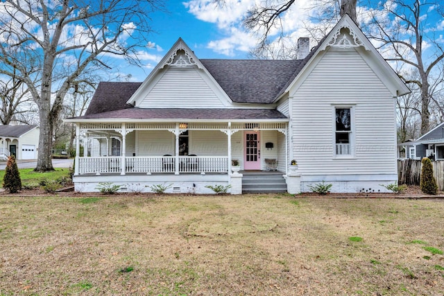 victorian-style house with a shingled roof, a chimney, a front yard, and a porch