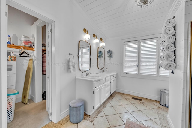 bathroom featuring crown molding, lofted ceiling, tile patterned floors, a sink, and double vanity