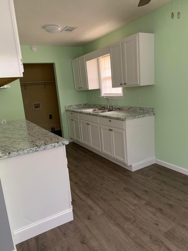 22 Harbin Ln, Haleyville, AL 35565 - kitchen with white cabinets, a sink, dark wood-type flooring, and visible vents