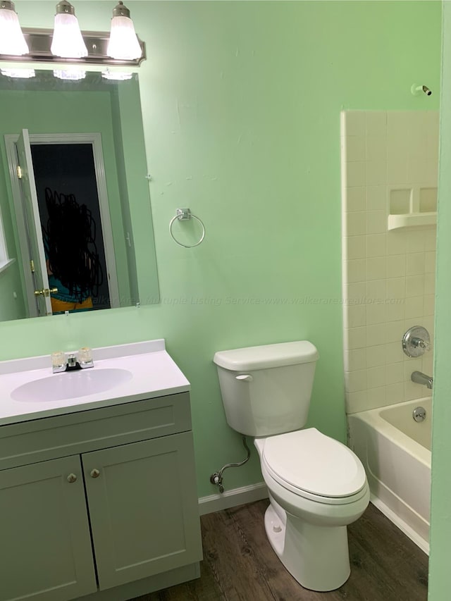 22 Harbin Ln, Haleyville, AL 35565 - bathroom with baseboards, wood finished floors, toilet, vanity, and shower / bathtub combination