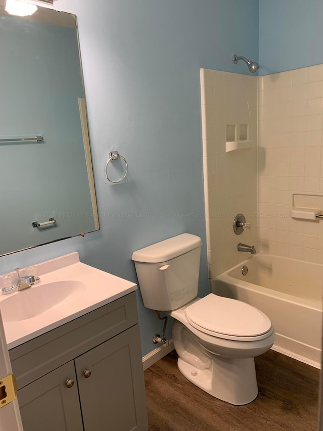 22 Harbin Ln, Haleyville, AL 35565 - full bath with baseboards, wood finished floors, toilet, vanity, and  shower combination