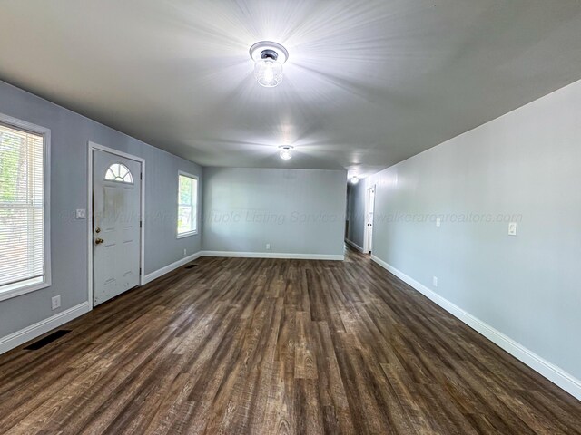 2214 SW 8 Th Ave, Fayette, AL 35555 - unfurnished living room featuring dark wood-type flooring and baseboards