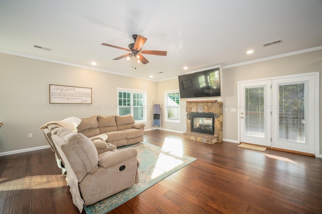 living area featuring baseboards, visible vents, ceiling fan, and hardwood / wood-style flooring