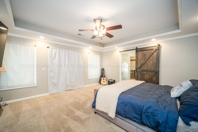 bedroom with crown molding, a raised ceiling, carpet floors, a barn door, and visible vents