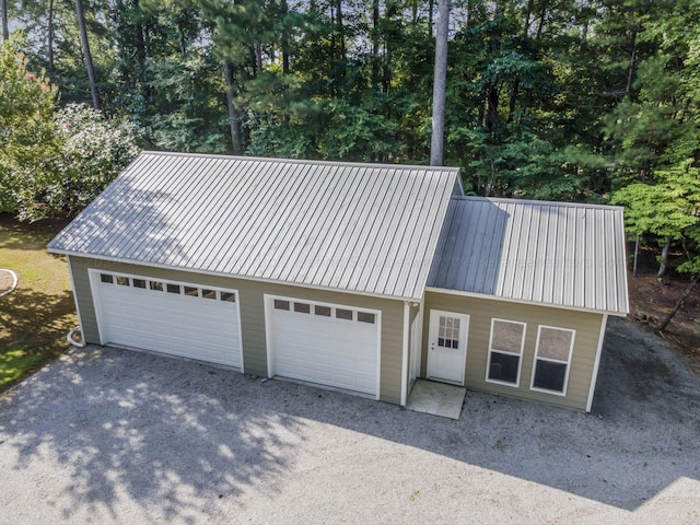 view of front of home with a garage and metal roof
