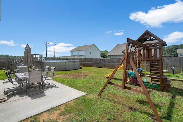 474 Meadow Way, Jasper, AL 35501 - fenced backyard with a playground, outdoor dining space, and a patio
