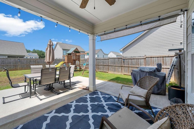 474 Meadow Way, Jasper, AL 35501 - fenced backyard featuring a playground, a ceiling fan, outdoor dining space, a patio area, and a residential view