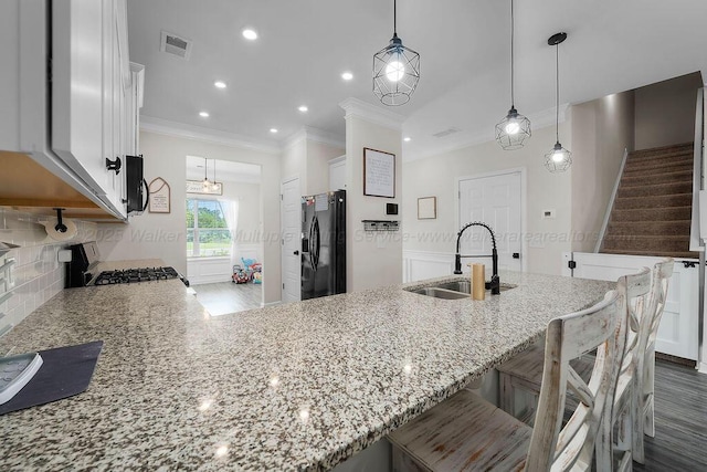 474 Meadow Way, Jasper, AL 35501 - kitchen featuring black appliances, light stone countertops, crown molding, white cabinets, and a peninsula