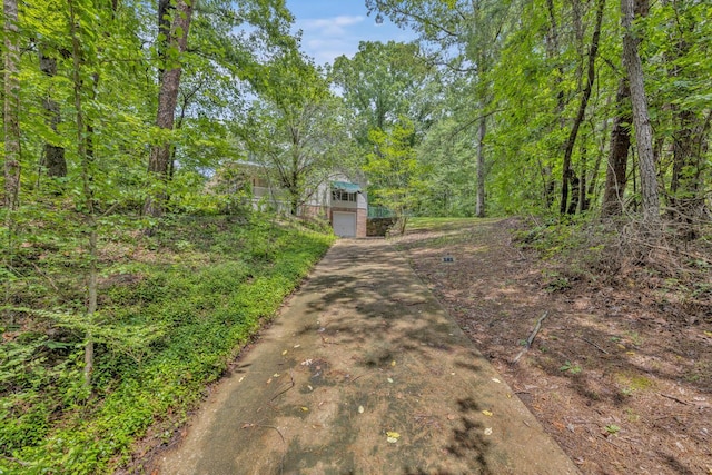 5305 Split Rail Dr, Jasper, AL 35503 - view of concrete driveway with a forest view