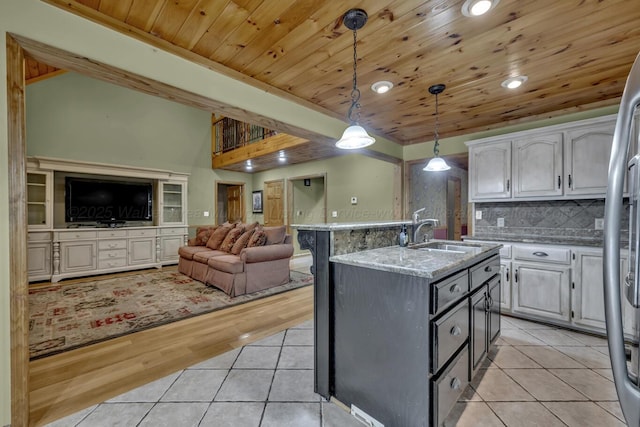 5305 Split Rail Dr, Jasper, AL 35503 - kitchen featuring light tile patterned flooring, wooden ceiling, open floor plan, decorative light fixtures, and light stone counters