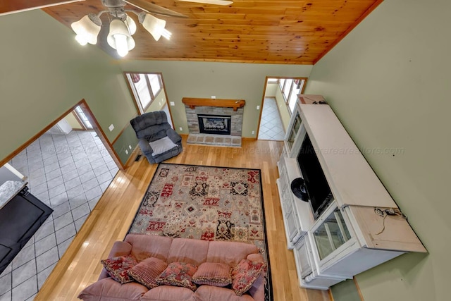 5305 Split Rail Dr, Jasper, AL 35503 - living room featuring lofted ceiling, ceiling fan, a stone fireplace, plenty of natural light, and wood ceiling