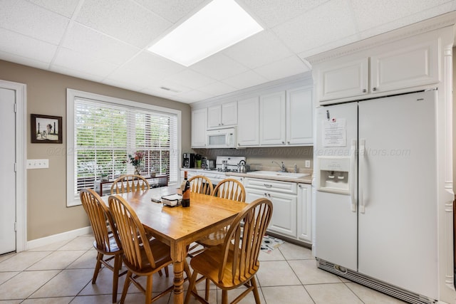 436 Ducktail Rd, Houston, AL 35572 - dining room with a paneled ceiling, light tile patterned flooring, and baseboards