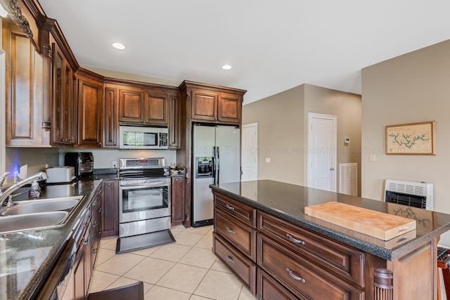 436 Ducktail Rd, Houston, AL 35572 - kitchen with appliances with stainless steel finishes, a sink, light tile patterned flooring, heating unit, and a center island