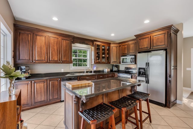 436 Ducktail Rd, Houston, AL 35572 - kitchen featuring stainless steel appliances, a breakfast bar area, light tile patterned flooring, dark countertops, and recessed lighting