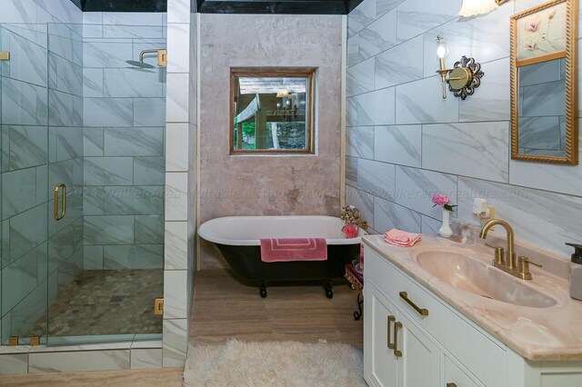 178 Turtle Ln, Houston, AL 35572 - bathroom featuring a shower stall, vanity, a freestanding bath, and tile walls