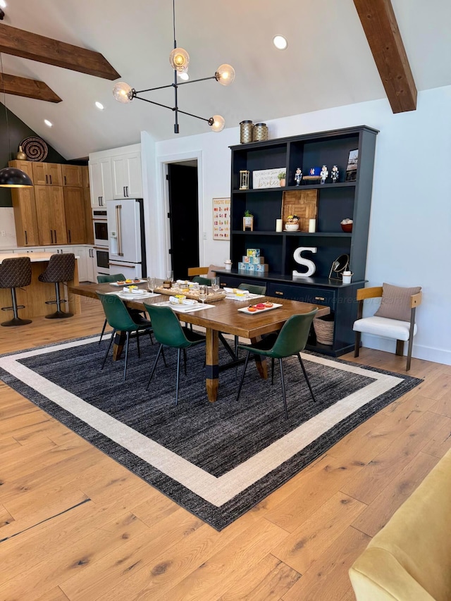 dining space with light wood finished floors and vaulted ceiling with beams