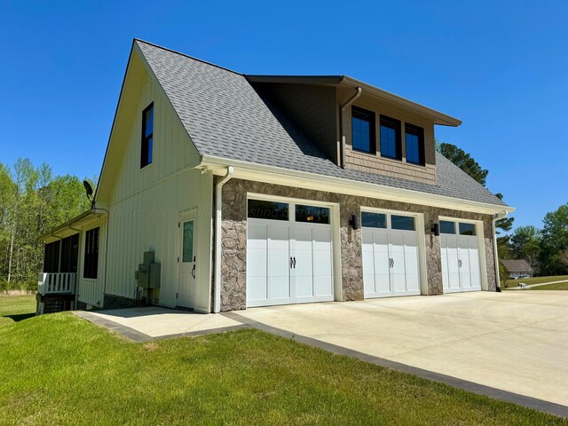 exterior space with board and batten siding, a lawn, and a shingled roof