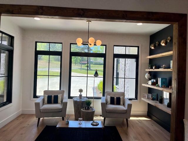 sitting room featuring baseboards, wood finished floors, recessed lighting, and a chandelier