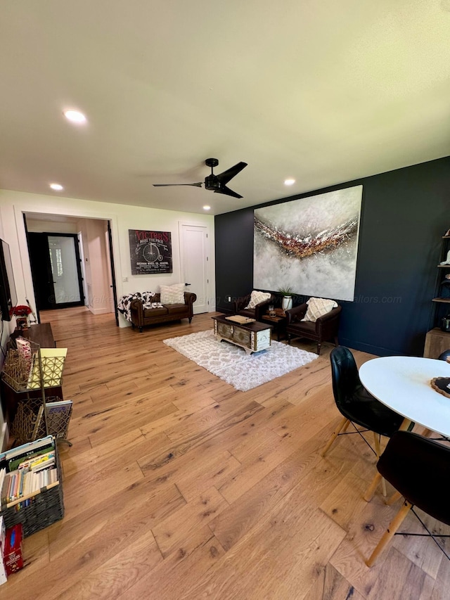 living area featuring a ceiling fan, recessed lighting, and wood-type flooring