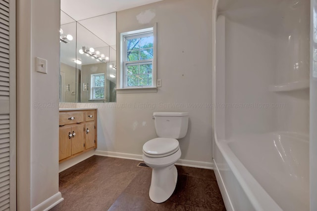 bathroom featuring tub / shower combination, vanity, toilet, and baseboards