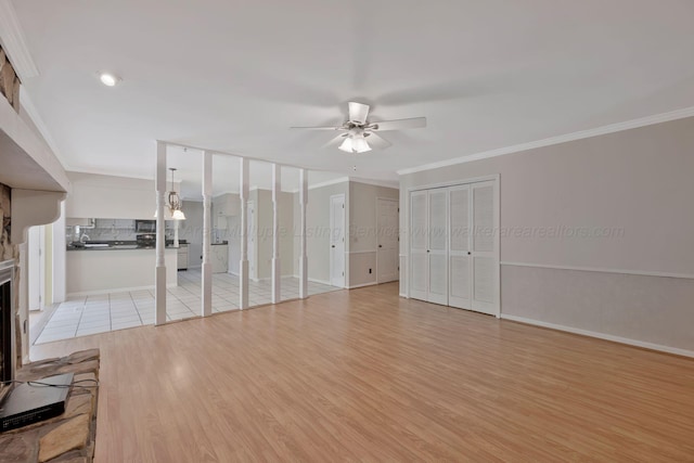 unfurnished living room featuring a ceiling fan, crown molding, light wood-type flooring, baseboards, and recessed lighting