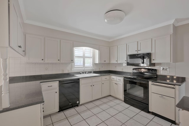 kitchen featuring dark countertops, a sink, white cabinetry, and black appliances