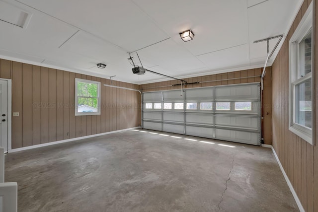 garage with wooden walls and a garage door opener