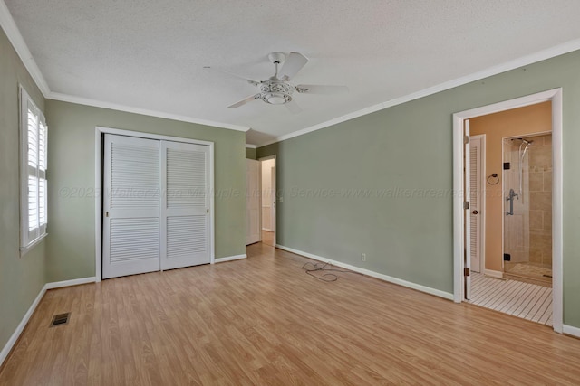 unfurnished bedroom featuring light wood-style flooring, baseboards, a closet, and ornamental molding