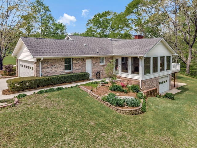 ranch-style house with concrete driveway, a garage, a shingled roof, a sunroom, and a front yard