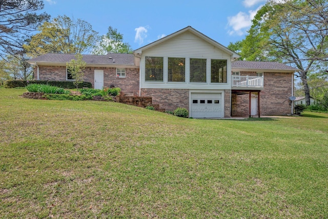 view of front of property with brick siding, an attached garage, and a front yard