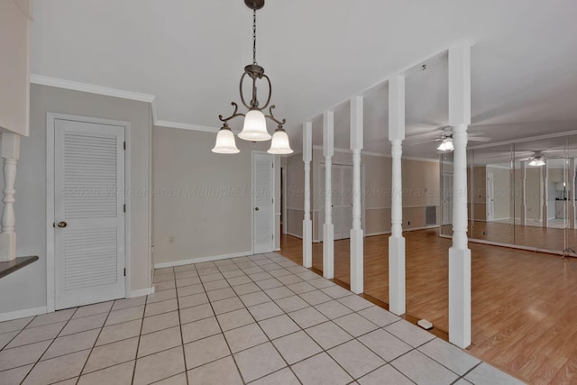 interior space with light wood-type flooring, ornamental molding, baseboards, and ceiling fan