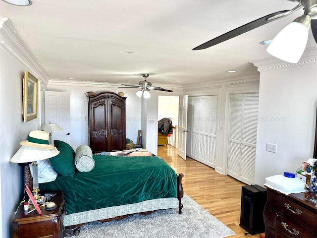 4963 Littleville Rd, Haleyville, AL 35565 - bedroom featuring crown molding, light wood-style flooring, recessed lighting, a ceiling fan, and multiple closets