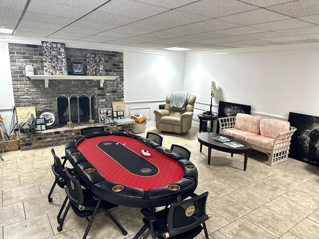 4963 Littleville Rd, Haleyville, AL 35565 - playroom featuring a fireplace, ornamental molding, tile patterned flooring, and wainscoting